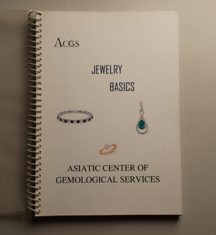 Cover of a white spiral-bound workbook titled Jewelry Basics by Asiatic Center of Gemological Services featuring images of a diamond bracelet ring and gemstone pendant